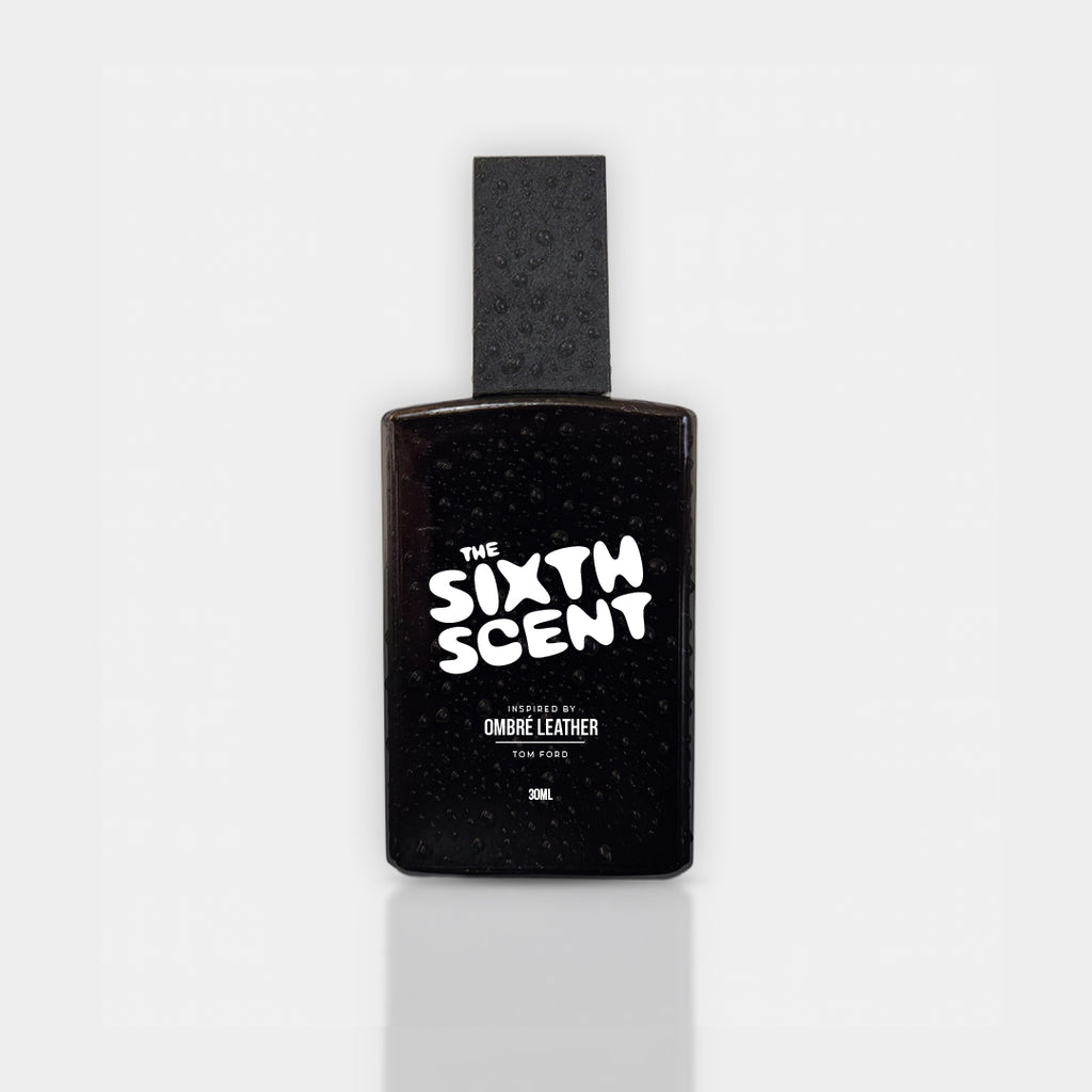 Dark-colored bottle of The Sixth Scent Leather Noir perfume with a sleek design and ombre leather label, emphasizing luxury and elegance.