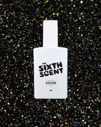 The Sixth Scent Midnight Opium perfume bottle with dark, elegant design and floral accents, showcasing a luxurious fragrance.